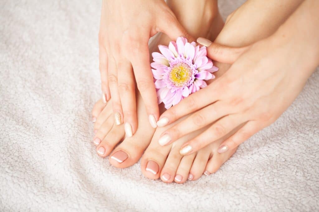 Hand and Nail Care. Beautiful Women's Feet and Hands After Manicure and Pedicure at Beauty Salon